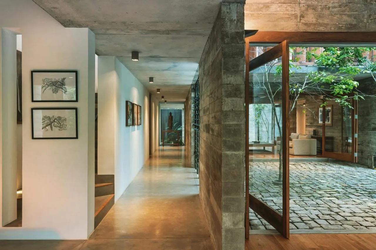 Modern interior with polished tile flooring and a planted courtyard